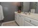 Bright bathroom featuring marble-top vanity, decorative greenery, and a large mirror at 7957 Preservation Dr, Indianapolis, IN 46278