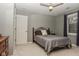 Cozy bedroom featuring a ceiling fan, a comfortable bed, and ample natural light from a window at 7957 Preservation Dr, Indianapolis, IN 46278