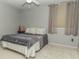 Comfortable bedroom with plush carpet, ceiling fan, and a large window for natural light at 7957 Preservation Dr, Indianapolis, IN 46278
