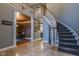 Inviting foyer featuring tile flooring, a staircase, and views into the dining and kitchen areas at 7957 Preservation Dr, Indianapolis, IN 46278