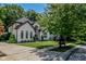 A well-manicured front yard complements this brick facade, two-story home featuring multiple archways and professional landscaping at 7957 Preservation Dr, Indianapolis, IN 46278