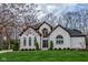 Charming brick two-story home with manicured lawn, arched windows, and a grand entrance at 7957 Preservation Dr, Indianapolis, IN 46278