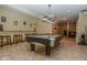 Spacious game room with a pool table, bar seating, and tile flooring throughout at 7957 Preservation Dr, Indianapolis, IN 46278