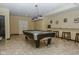 Spacious game room with a pool table, bar seating, and tile flooring throughout at 7957 Preservation Dr, Indianapolis, IN 46278