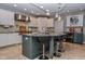 Modern kitchen with white cabinetry, granite countertops, an island with seating, and stainless steel appliances at 7957 Preservation Dr, Indianapolis, IN 46278