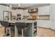 A large kitchen island is the focal point of this kitchen with stainless appliances and pendant lights at 7957 Preservation Dr, Indianapolis, IN 46278