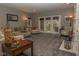 Spacious living room featuring neutral décor, a decorative fireplace, and French doors leading to the outside at 7957 Preservation Dr, Indianapolis, IN 46278