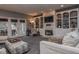 This living room is complete with a stone fireplace, built-in bookshelves, and French doors to the patio at 7957 Preservation Dr, Indianapolis, IN 46278