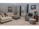 Stylish living room featuring neutral-toned furniture, including a large sectional and patterned armchairs at 7957 Preservation Dr, Indianapolis, IN 46278
