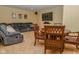 Spacious living room featuring a large sofa, wood table and chairs, and entertainment center at 7957 Preservation Dr, Indianapolis, IN 46278