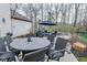 Comfortable outdoor patio with a round dining table, chairs, lounge seating and a firepit at 7957 Preservation Dr, Indianapolis, IN 46278