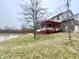 A backyard view shows a well-maintained yard, a scenic pond, and a charming deck space at 8201 E 250 S, Zionsville, IN 46077