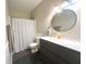 Modern bathroom with sleek vanity, round mirror, and patterned shower curtain at 8201 E 250 S, Zionsville, IN 46077