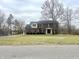 Two-story brick home featuring dark shutters, a covered entryway, and a large front lawn at 8201 E 250 S, Zionsville, IN 46077