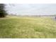 New real estate development with a large grassy field, landscaping, and construction markers on a sunny day at 8201 E 250 S, Zionsville, IN 46077
