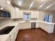 Bright kitchen featuring white cabinets, quartz countertops, stainless steel appliances, and wood flooring at 8201 E 250 S, Zionsville, IN 46077
