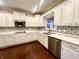 Bright kitchen featuring white cabinets, quartz countertops, stainless steel appliances, and decorative backsplash at 8201 E 250 S, Zionsville, IN 46077