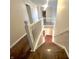 Elegant staircase with white railing and hardwood steps leading to a lower level at 8201 E 250 S, Zionsville, IN 46077