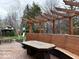 Outdoor living space with a deck, pergola, seating, and a fire table for relaxation at 8212 N Sierra Dr, Muncie, IN 47303