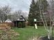 A charming backyard with playhouse and mature trees, perfect for Gathering activities at 8212 N Sierra Dr, Muncie, IN 47303