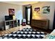 Bedroom with natural light, dresser, and video game decor on the wall at 8212 N Sierra Dr, Muncie, IN 47303