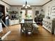 Bright dining room with hardwood floors, a farmhouse table, stylish decor, and an abundance of natural light at 8212 N Sierra Dr, Muncie, IN 47303