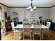 Inviting dining room with hardwood floors, a farmhouse table, a stylish chandelier, decor, and an abundance of natural light at 8212 N Sierra Dr, Muncie, IN 47303