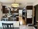 Spacious kitchen area with dining area, featuring dark wood cabinets at 8212 N Sierra Dr, Muncie, IN 47303