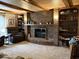 Inviting living room featuring a brick fireplace, wood accents, and comfortable seating at 8212 N Sierra Dr, Muncie, IN 47303