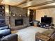 Cozy living room with a brick fireplace, wooden ceiling beams and comfortable seating at 8212 N Sierra Dr, Muncie, IN 47303