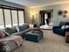 Inviting living room featuring neutral colors, a sectional sofa, ottoman, a cozy chair, and natural light at 8212 N Sierra Dr, Muncie, IN 47303