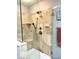 Luxurious walk-in shower with neutral-toned tile and a hand-held sprayer at 8212 N Sierra Dr, Muncie, IN 47303