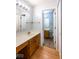 Bathroom featuring double sinks, white counters, and view of the adjacent bathroom at 9029 Crook N Dr, Indianapolis, IN 46256