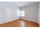 Neutral bedroom with hardwood floors and a bright window with plantation shutters at 9029 Crook N Dr, Indianapolis, IN 46256