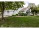 Charming home featuring light blue siding, attached garage, and meticulously landscaped front yard at 9029 Crook N Dr, Indianapolis, IN 46256