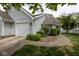 Charming home featuring light blue siding, attached garage, and meticulously landscaped front yard at 9029 Crook N Dr, Indianapolis, IN 46256