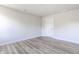 A bright bedroom features a window, light gray walls, gray-toned flooring and a white door at 955 Sand Hollow Dr, Lebanon, IN 46052
