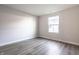 A bright bedroom features a window, light gray walls, and stylish gray-toned flooring at 955 Sand Hollow Dr, Lebanon, IN 46052