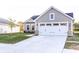 Charming single-Gathering home featuring a two-car garage, stone accents, and well-manicured front lawn at 955 Sand Hollow Dr, Lebanon, IN 46052
