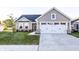 Charming single-Gathering home featuring a two-car garage, stone accents, and well-manicured front lawn at 955 Sand Hollow Dr, Lebanon, IN 46052