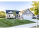 Charming single-Gathering home featuring a two-car garage, stone accents, and well-manicured front lawn at 955 Sand Hollow Dr, Lebanon, IN 46052