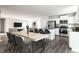 Bright kitchen with an island and seating, stainless steel appliances, and an attached living room at 955 Sand Hollow Dr, Lebanon, IN 46052