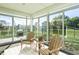 Enclosed patio features sliding glass windows and Adirondack chairs at 955 Sand Hollow Dr, Lebanon, IN 46052
