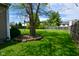 Lush backyard featuring a mature tree with stone accents, offering ample space for outdoor activities at 10622 Young Lake Dr, Indianapolis, IN 46239