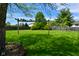 Expansive backyard featuring a wooden pergola and lush green grass at 10622 Young Lake Dr, Indianapolis, IN 46239