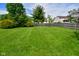 Large backyard with a level lawn, mature trees, and a full fence at 10622 Young Lake Dr, Indianapolis, IN 46239