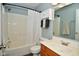 Well-lit bathroom with a shower-tub combination, complemented by a functional vanity and cabinet at 10622 Young Lake Dr, Indianapolis, IN 46239