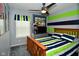 Inviting bedroom with striped bedding, a ceiling fan, and colorful wall decor at 10622 Young Lake Dr, Indianapolis, IN 46239