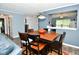 Dining area open to the living space, featuring hardwood flooring, a pass-through to the kitchen and a modern light fixture at 10622 Young Lake Dr, Indianapolis, IN 46239