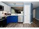 Updated kitchen featuring two-tone cabinetry, stainless steel appliances, and a pass-through to the adjacent dining area at 10622 Young Lake Dr, Indianapolis, IN 46239
